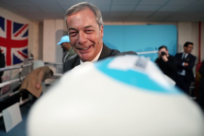 Brexit Party leader Nigel Farage wears boxing gloves during a visit at a boxing gym in Ilford