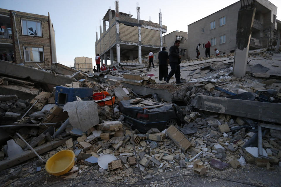 People including rescue personnel conduct search and rescue work following a 7.3-magnitude earthquake at Sarpol-e Zahab in Iran's Kermanshah province on November 13, 2017. Photo by POURIA PAKIZEH/AFP/Getty Images.