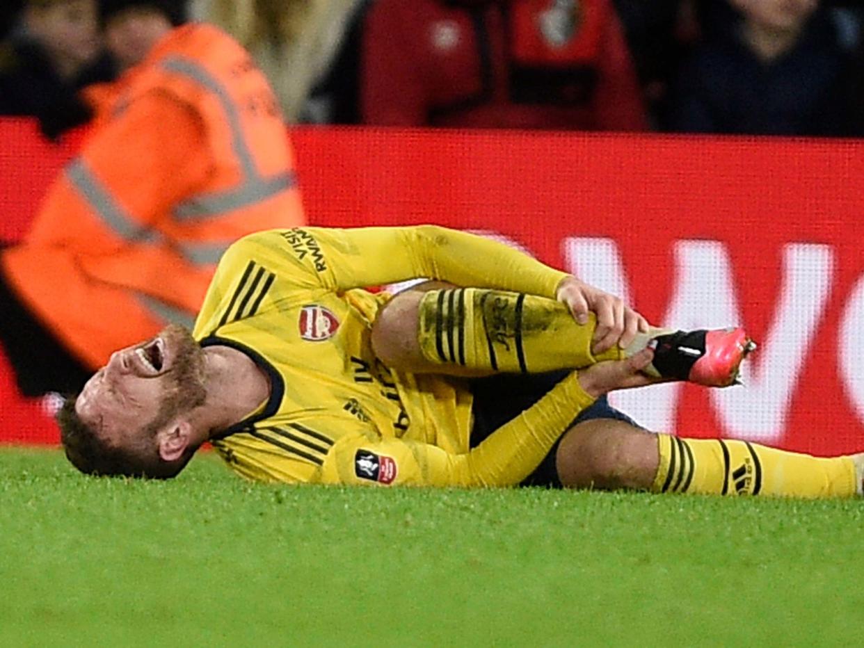 Shkodran Mustafi of Arsenal goes down injured: EPA