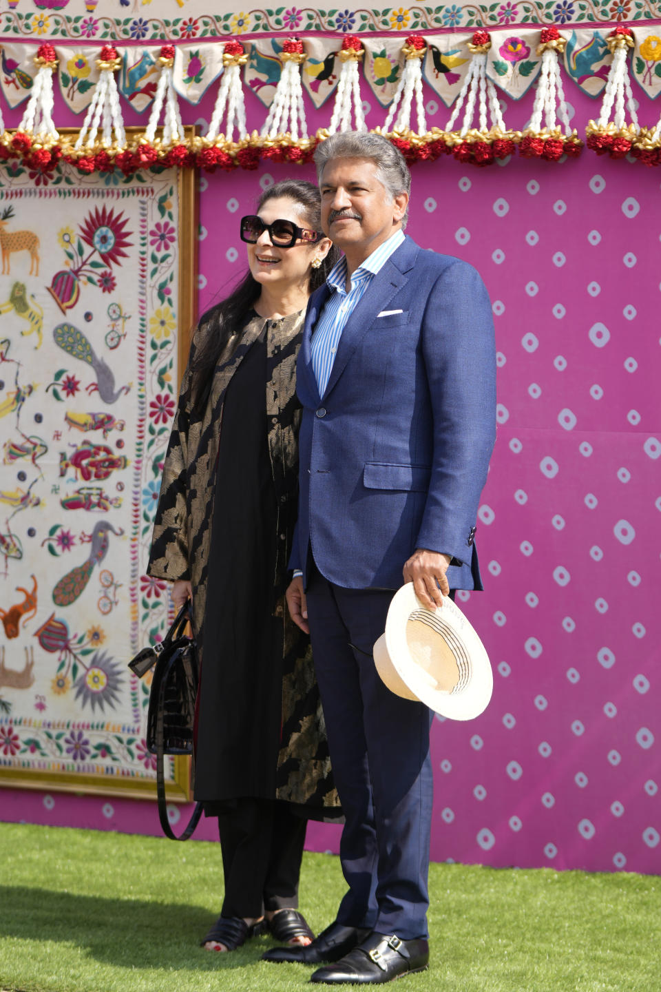 Anand Mahindra, chairperson of Mahindra and Mahindra, poses with his wife Anuradha as they arrive to attend a pre-wedding bash of billionaire industrialist Mukesh Ambani's son Anant Ambani, in Jamnagar, India, Friday, March 1, 2024. (AP Photo/Ajit Solanki)