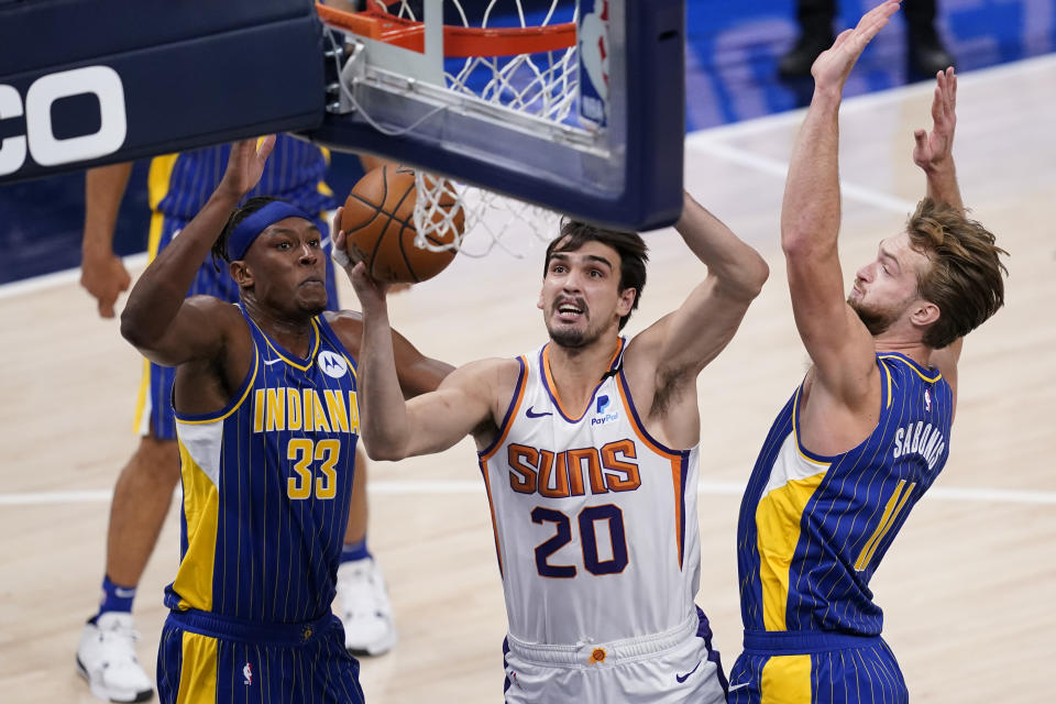 Phoenix Suns' Dario Saric (20) shoots against Indiana Pacers' Myles Turner (33) and Domantas Sabonis (11) during the first half of an NBA basketball game, Saturday, Jan. 9, 2021, in Indianapolis. (AP Photo/Darron Cummings)