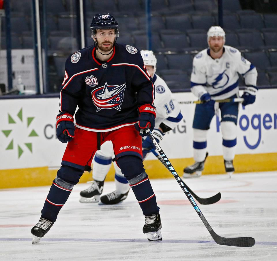 Columbus Blue Jackets right wing Oliver Bjorkstrand (28) watches the puck against Tampa Bay Lightning in the third period during their NHL game at Nationwide Arena in Columbus, Ohio on January 23, 2021. 