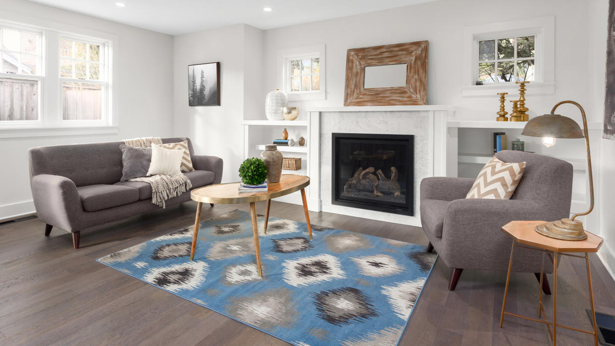  Blue rug in middle of living room floor 