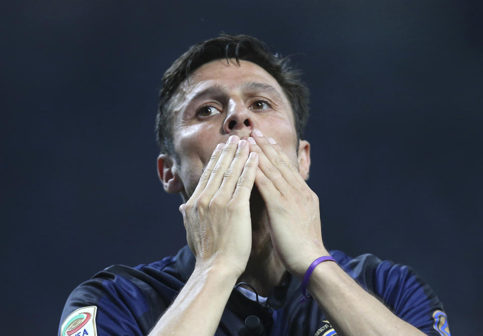 Inter Milan's Javier Zanetti,of Argentina greets his fans at the end of the Serie A soccer match between Inter Milan and Lazio at the San Siro stadium in Milan, Italy, Saturday, May 10, 2014. Zanetti will retire after 19 seasons at Inter, and the stadium was sold out as fans packed in to bid farewell to their 40-year-old captain. (AP Photo/Antonio Calanni)