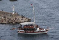 Tourist take a boat trip in Antalya, southern Turkey, Monday, June 21, 2021. Hotels in Turkey's Antalya region, a destination beloved by holidaymakers, are preparing to finally resume operations as they expect the return of international tourists after months of setbacks caused by the pandemic that halted travel. (AP Photo/Emrah Gurel)