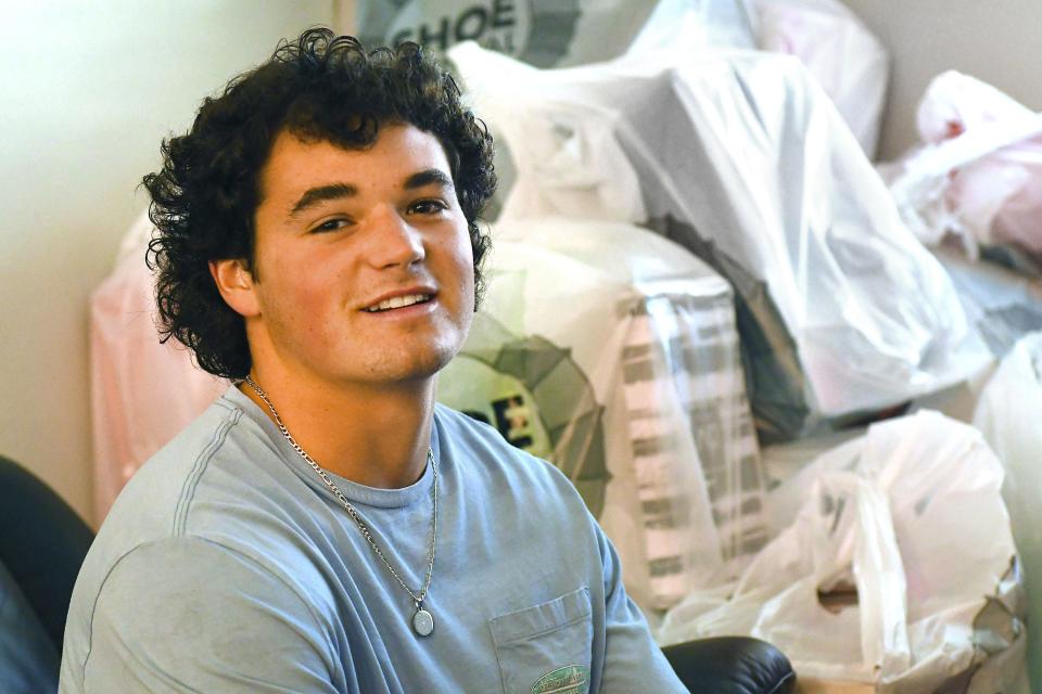 Gunner Robinson a New Hanover High School football player, has been collecting shoes for years and giving them to those in need. Boxes of shoes wait to be donated Monday Aug. 15, 2022 at the home of Robinson. The shoes will be donated through Gunner Robinson's charity and distributed to those that need them in our local counties. KEN BLEVINS/STARNEWS