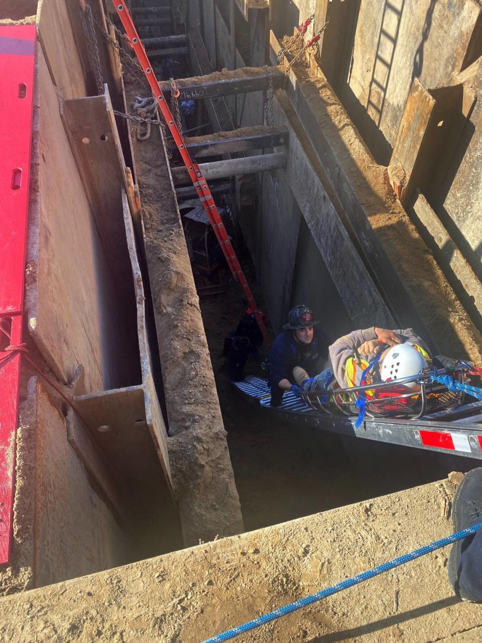 Modesto firefighters rescue a man who fell nearly 30 feet behind a metal plate holding a trench together where a construction crew is installing sewer pipes.