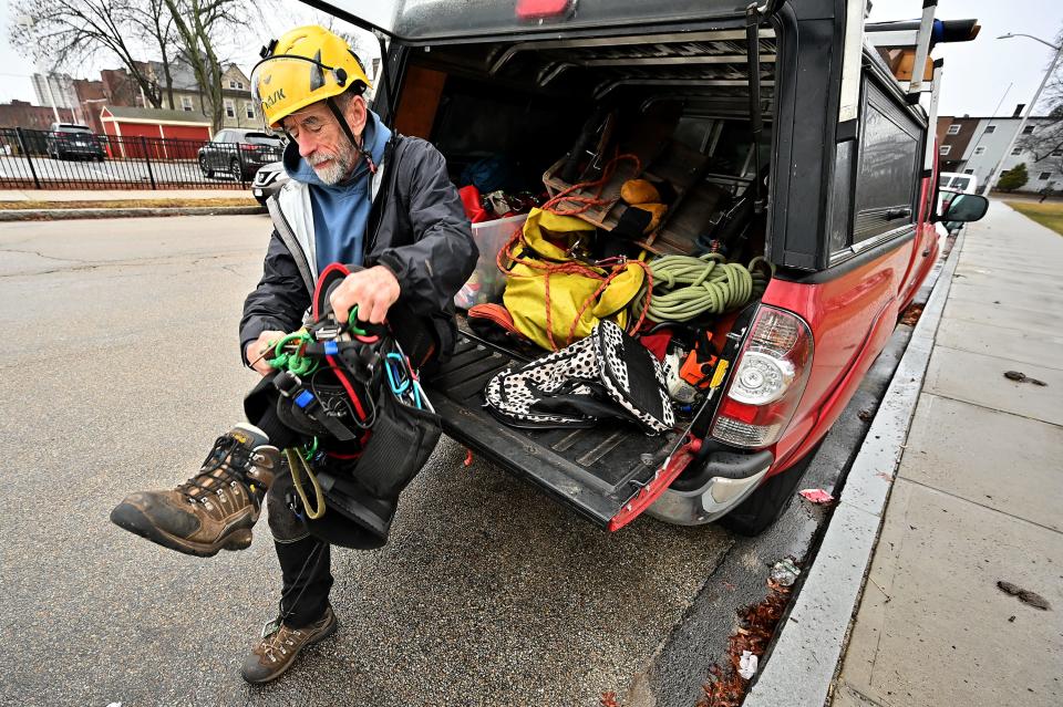 Andrew Joslin of Carlisle, who rescues cats from trees, shows some of his gear.