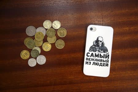 A mobile phone cover depicting Russian President Vladimir Putin and which reads "The most polite person" is seen in this photo illustration taken in a hotel room in Kazan, Russia, August 5, 2015. REUTERS/Stefan Wermuth