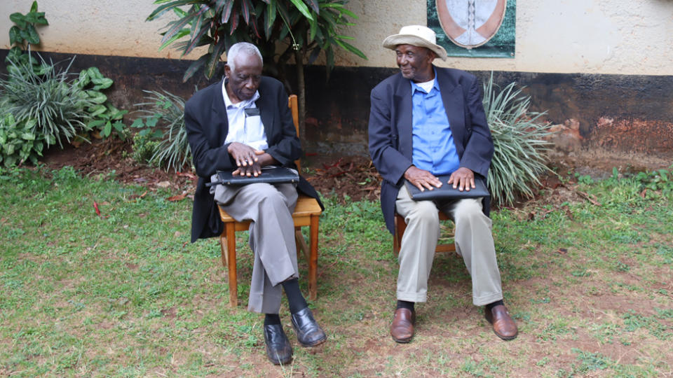 Two men sitting next to each other