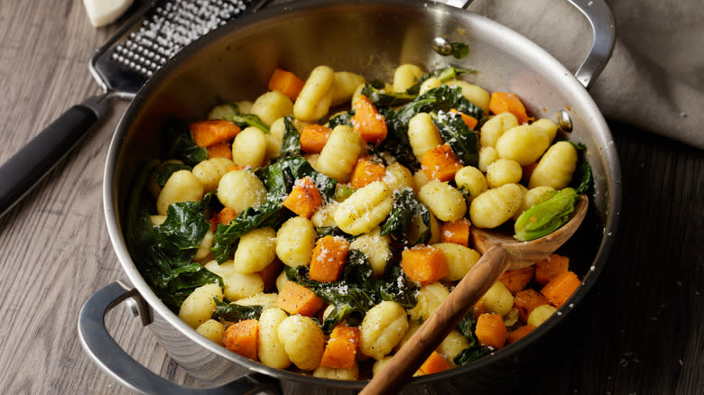 Gnocchi with vegetables in pan