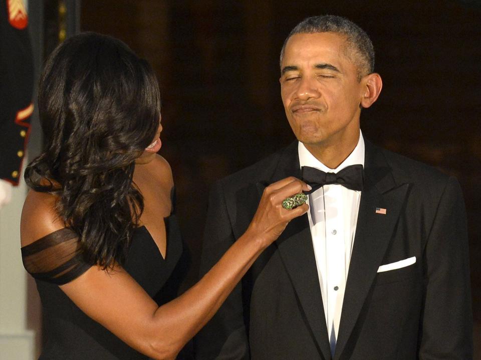 Michelle Obama fixes barack obama's bow tie