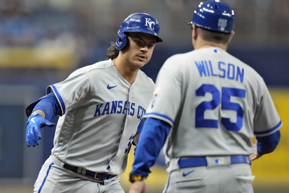Kansas City Royals' Nick Pratto celebrates with third base coach Vance Wilson (25) after hitting a home run off Tampa Bay Rays starting pitcher Zach Eflin during the first inning of a baseball game Friday, June 23, 2023, in St. Petersburg, Fla. (AP Photo/Chris O'Meara)