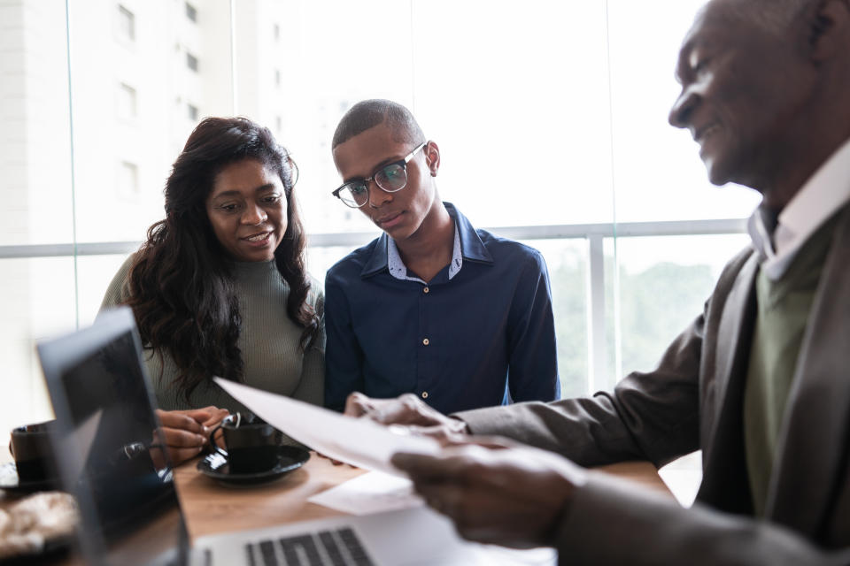 Mother and son in a meeting with a real estate agent or financial advisor at home