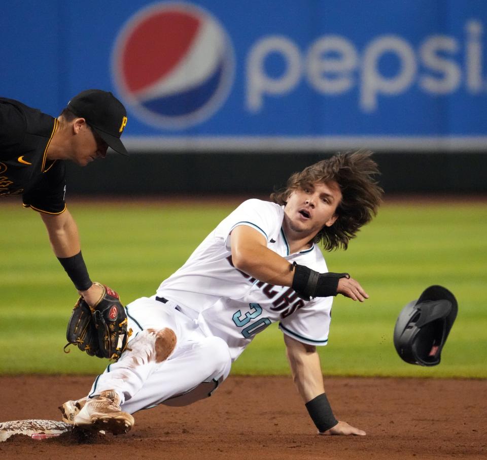 Aug. 9: The Arizona Diamondbacks' Jake McCarthy beats the tag of Pittsburgh Pirates shortstop Kevin Newman to steal second base during the third inning at Chase Field.