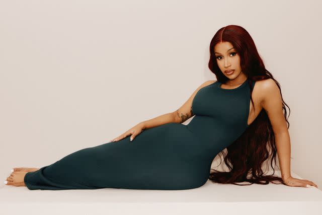 <p>SKIMS</p> Cardi B models a cotton dress for SKIMS' latest campaign.