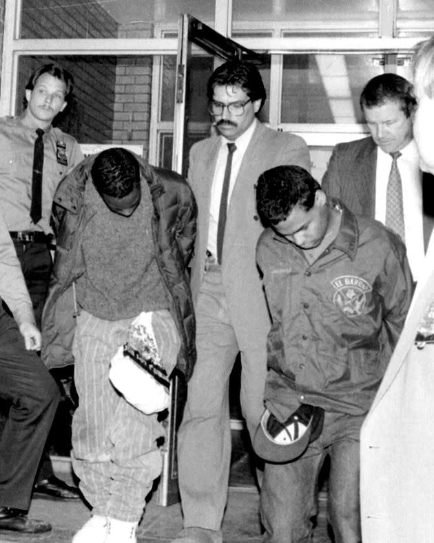 Defendants Clarence Thomas (left) and Steven Lopez (right) are seen being escorted by New York City police detectives following the 1989 rape and assault of a jogger. (Photo: New York Daily News Archive via Getty Images)