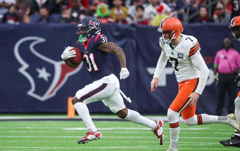 Houston Texans running back Dameon Pierce (31) runs past Cleveland Browns kicker Dustin Hopkins (7) to score a touchdown on a kickoff return Dec. 24 in Houston.