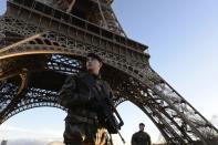 French soldiers patrol in front of the Eiffel Tower on January 8, 2015 in Paris as the capital was placed under the highest alert