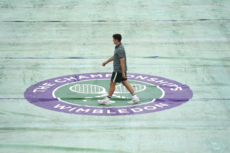 Gorundstaff prepare the covers at the All England Lawn Tennis and Croquet Club in Wimbledon, London, Britain, ahead of the championships starting tomorrow, on Sunday, July 2, 2023. (John Walton/PA via AP)