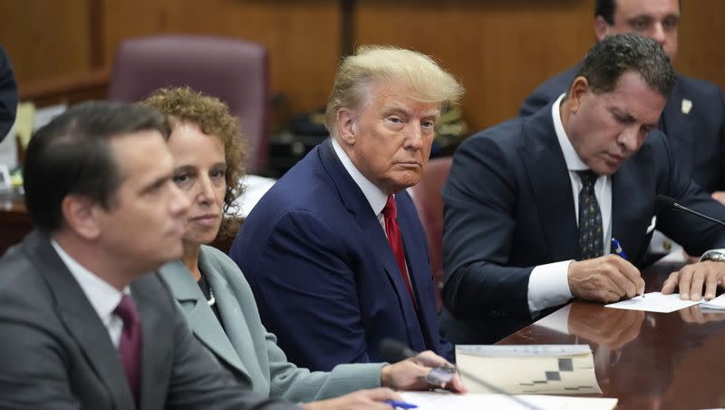 Former President Donald Trump sits at the defense table with his defense team in a Manhattan court, Tuesday, April 4, 2023, in New York. Trump is set to appear in a New York City courtroom on charges related to falsifying business records in a hush money investigation, the first president ever to be charged with a crime.