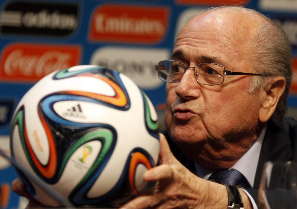 FIFA President Sepp Blatter holds an official 2014 FIFA World Cup soccer ball during a media conference in Sao Paulo June 5, 2014. The 2014 World Cup will be held in 12 cities in Brazil from June 12 to July 13. REUTERS/Paulo Whitaker (BRAZIL - Tags: SPORT SOCCER WORLD CUP)