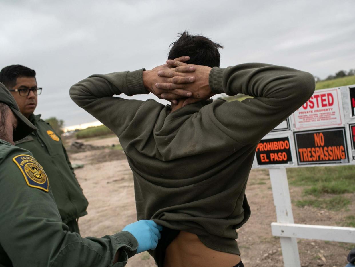 US Border Patrol agents detain undocumented immigrants caught near a section of privately-built border wall under construction: Getty Images