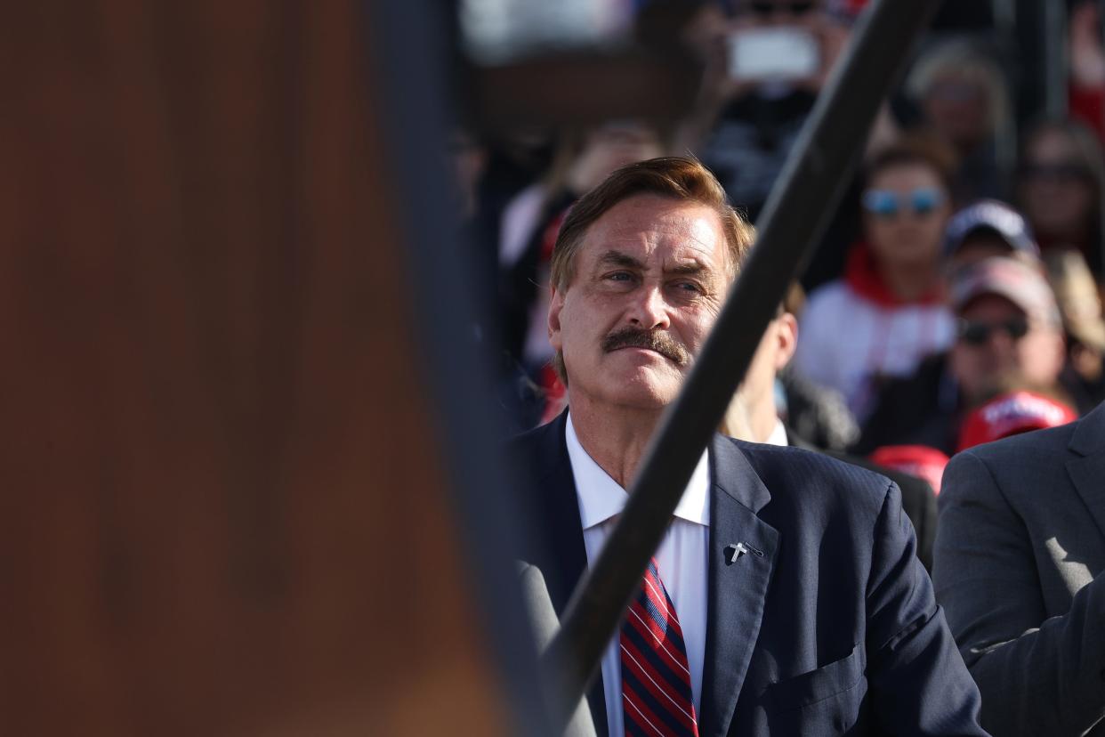 My Pillow CEO Mike Lindell listens as former President Donald Trump speaks to supporters during a rally at the I-80 Speedway on May 01, 2022 in Greenwood, Nebraska. Trump is supporting Charles Herbster in the Nebraska gubernatorial race.