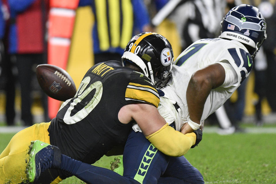 Seattle Seahawks quarterback Geno Smith (7) fumbles as Pittsburgh Steelers outside linebacker T.J. Watt (90) tackles him during overtime of an NFL football game, Sunday, Oct. 17, 2021, in Pittsburgh. The Steelers won 23-20 in overtime. Steelers linebacker Devin Bush recovered the fumble and the Steelers kicked a field goal to win. (AP Photo/Don Wright)