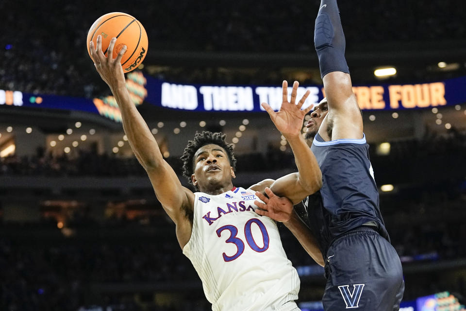 FILE - Then-Kansas guard Ochai Agbaji (30) shoots around Villanova forward Eric Dixon during the second half of a college basketball game in the semifinal round of the Men's Final Four NCAA tournament, Saturday, April 2, 2022, in New Orleans. Cleveland made its acquisition of All-Star guard Donovan Mitchell in a trade with Utah official on Saturday, Sept. 3. Cleveland sent guard Collin Sexton, guard Lauri Markkanen and rookie guard Ochai Agbaji to Utah along with unprotected first-round draft picks in 2025, 2027 and 2029. (AP Photo/David J. Phillip, File)