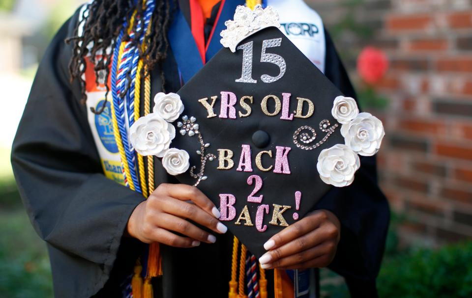 Shania Muhammad, 15, holds her mortar board Wednesday at her home in Oklahoma City.