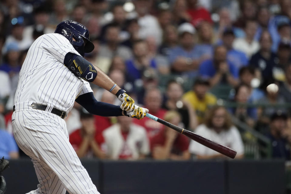 Milwaukee Brewers' Rowdy Tellez hits a two-run home run during the first inning of the team's baseball game against the Cincinnati Reds on Friday, Aug. 5, 2022, in Milwaukee. (AP Photo/Aaron Gash)