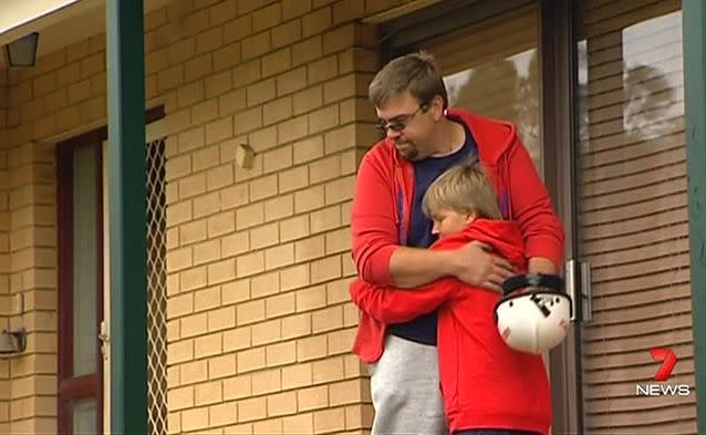 Josh, ten, and his dad, Craig, survey the damage. Credit: 7News