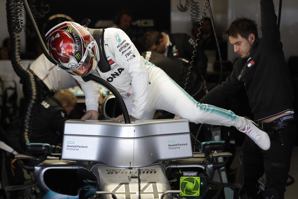 Mercedes driver Lewis Hamilton, of Britain, climbs into his car during first practice session for the Formula One U.S. Grand Prix auto race at the Circuit of the Americas, Friday, Nov. 1, 2019, in Austin, Texas. (AP Photo/Darron Cummings)