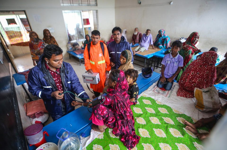 A doctor attends to people who were evacuated due to Cyclone Remal at a shelter in Shyamnagar, Satkhira District, Bangladesh, Monday, May 27, 2024. (AP Photo/Abdul Goni)