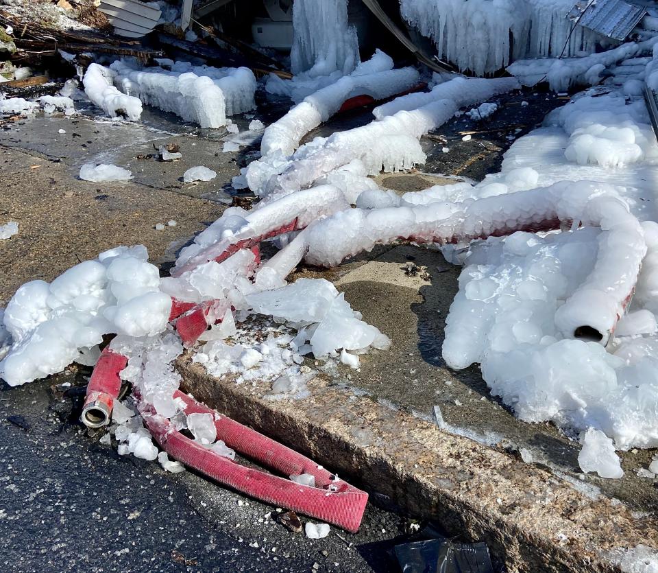 A couple of discarded fire hoses can be seen where firefighters fought a blaze that leveled an apartment house at 140 Irving St.