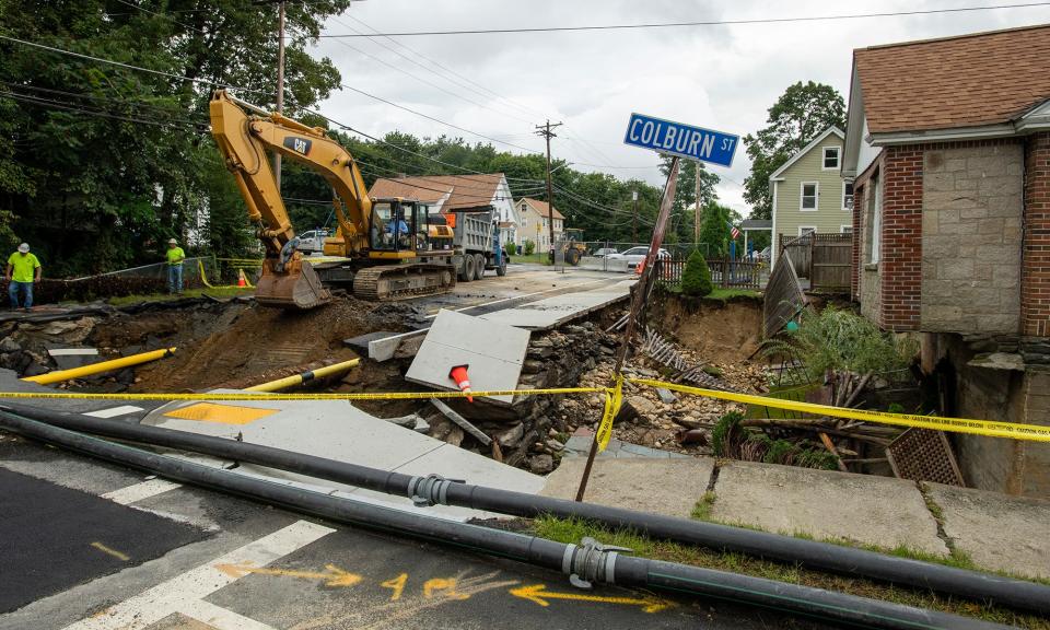 Two days after the Sept. 11 flooding, workers repairing the intersection of Pleasant and Colburn streets.