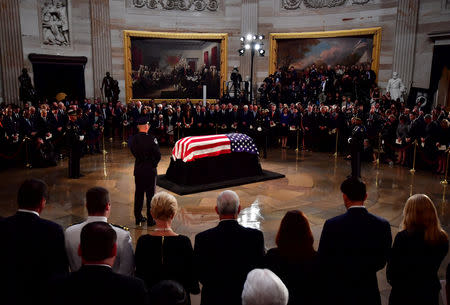 Mourners surround the casket of former Senator John McCain in the Capitol Rotunda where he will lie in state at the U.S. Capitol, in Washington, DC on Friday, August 31, 2018. McCain, an Arizona Republican, presidential candidate and war hero died August 25th at the age of 81. He is the 31st person to lie in state at the Capitol in 166 years. Kevin Dietsch/POOL Via REUTERS