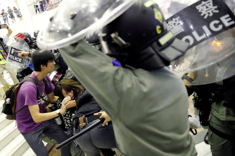 People scuffle with riot police at a shopping mall in Tai Po in Hong Kong
