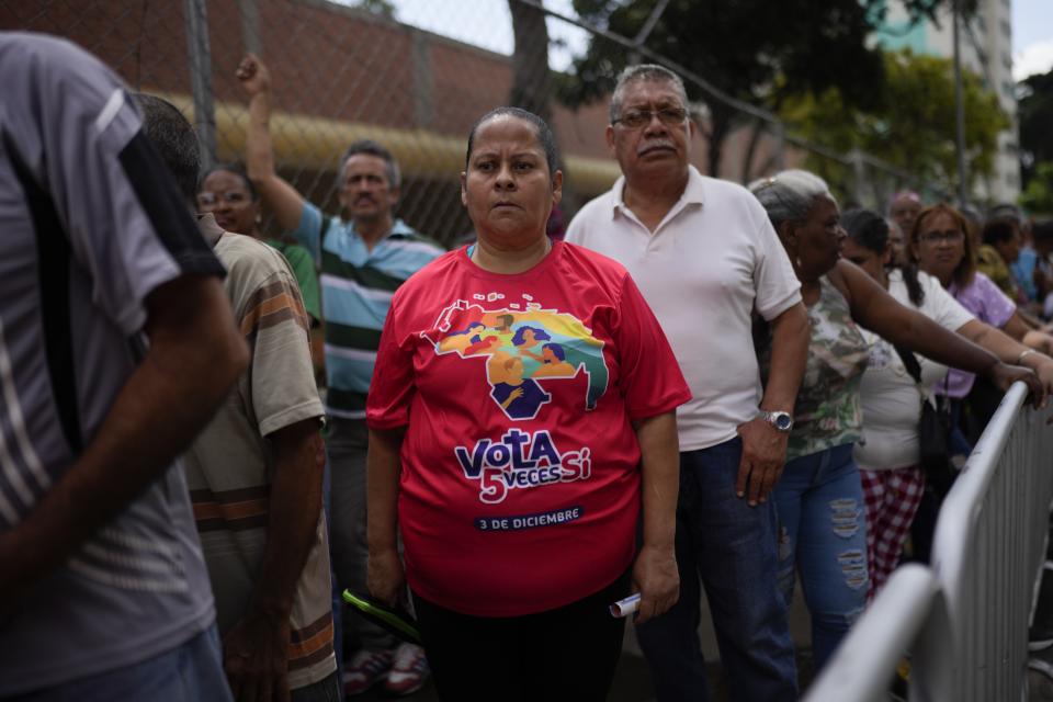 People lineup outside a school to participate in a voting rehearsal for the upcoming December 3 referendum for the territorial dispute between Guyana and Venezuela, in Caracas, Venezuela, Sunday, Nov. 19, 2023. (AP Photo/Ariana Cubillos)