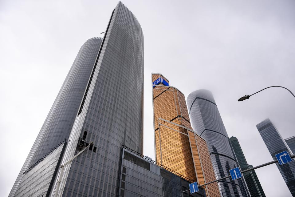 Workers clean a part of a damaged skyscraper in the "Moscow City" business district after a reported drone attack in Moscow, Russia, Wednesday, Aug. 23, 2023. Russia's defense ministry and Moscow's mayor said Ukrainian drones were downed in Moscow and the region around the capital early Wednesday. No casualties were reported. (AP Photo)