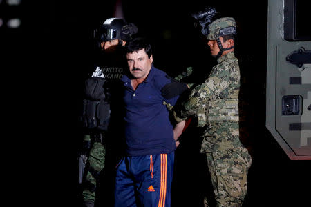 FILE PHOTO: FILE PHOTO: Joaquin "El Chapo" Guzman is escorted by soldiers during a presentation in Mexico City, Jan. 8, 2016. REUTERS/Tomas Bravo/File Photo/File Photo -/File Photo