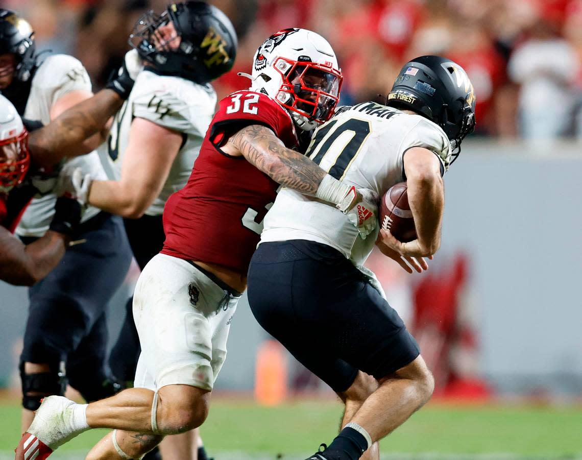 N.C. State linebacker Drake Thomas (32) sacks Wake Forest quarterback Sam Hartman (10) during the second half of N.C. State’s 30-21 victory over Wake Forest at Carter-Finley Stadium in Raleigh, N.C., Saturday, Nov. 5, 2022.