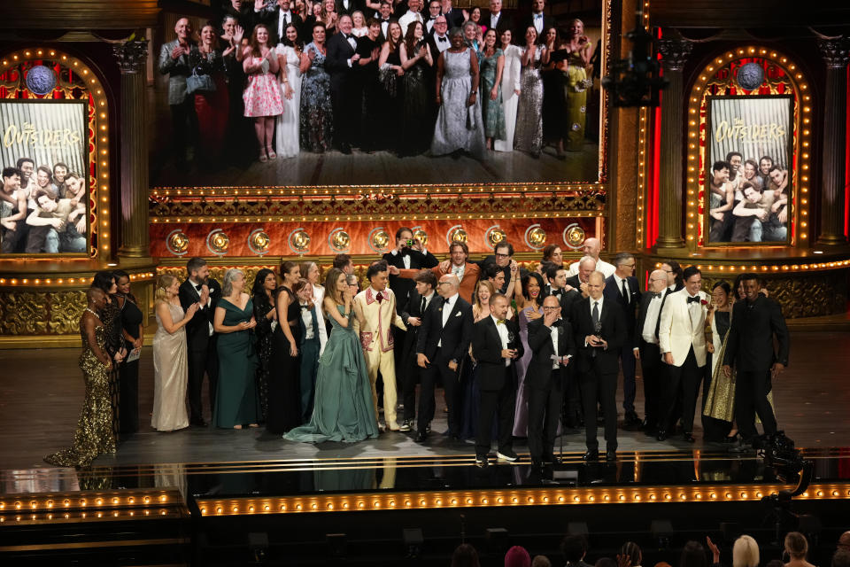 Michael Rego, from center left, Matthew Rego, and Hank Unger and members of the company of "The Outsiders " accept the award for best musical during the 77th Tony Awards on Sunday, June 16, 2024, in New York. (Photo by Charles Sykes/Invision/AP)