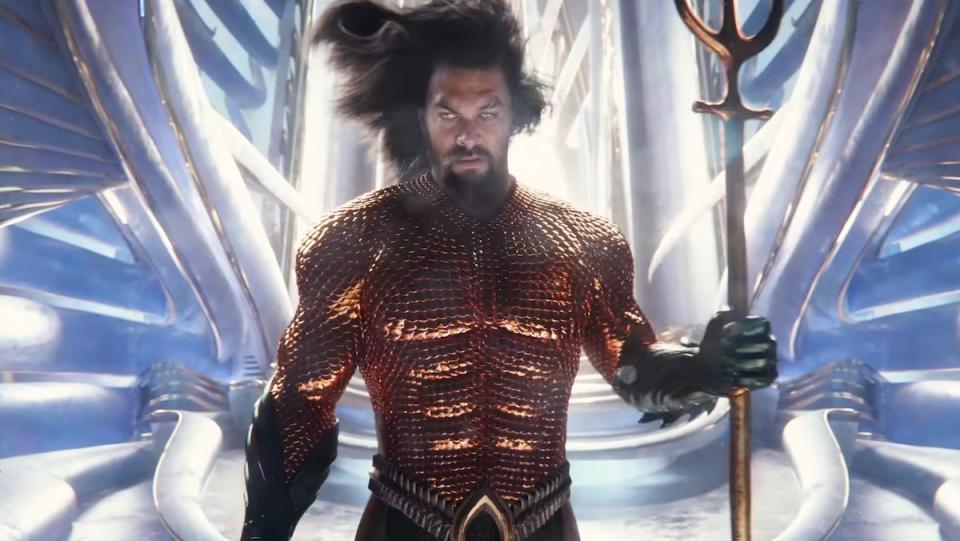 Aquaman in his armor holding his trident with his hair moving in the water in The Lost Kingdom