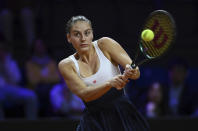 Ukraine's Marta Kostyuk returns the ball to Coco Gauff of the United States during her quarterfinals tennis match at the WTA Tour in Stuttgart, Germany, Friday April 19, 2024. (Marijan Murat/dpa via AP)