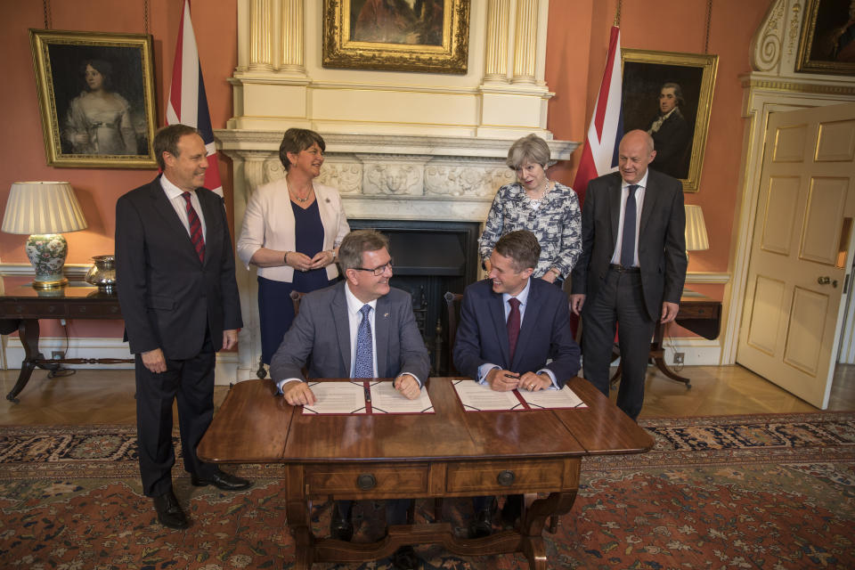 Theresa May signs a deal with the DUP’s Arlene Foster, Nigel Dodds and Sir Geoffrey Donaldson after losing the Conservative Party’s majority in the 2017 General Election (Getty Images)