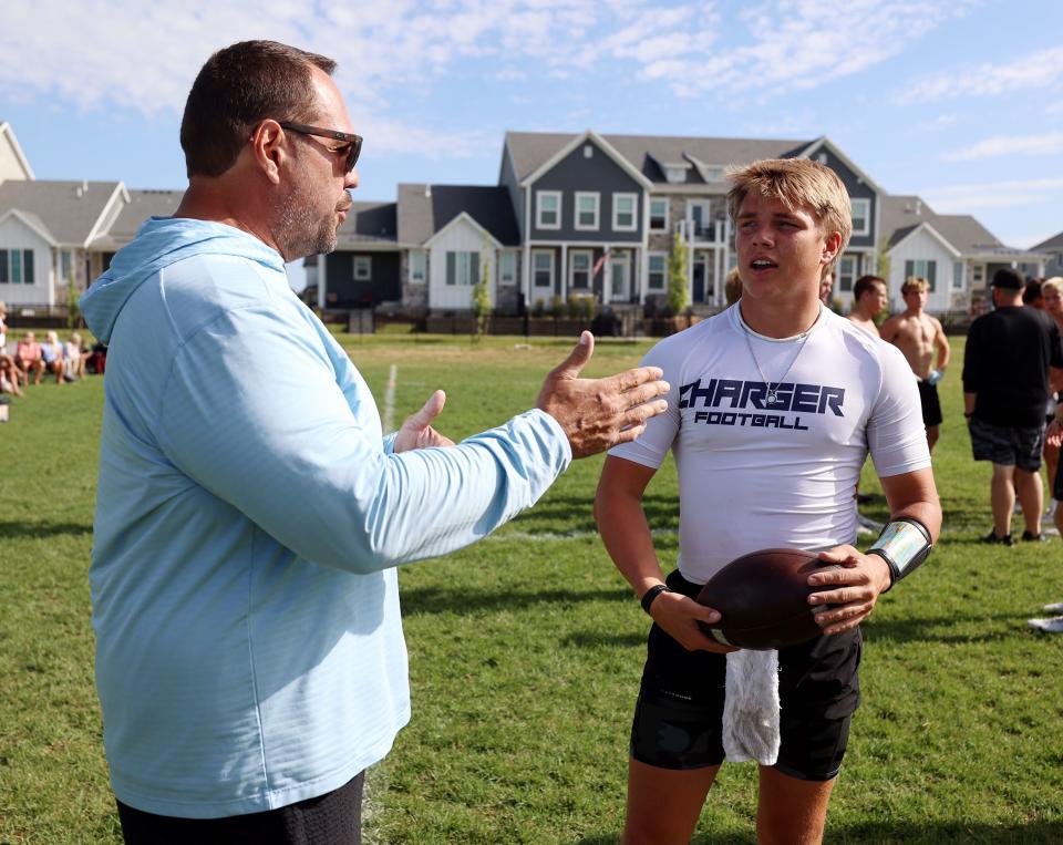 Mike Wilson talks with his son Isaac Wilson during a 7-on-7 passing league game in Layton on Friday, June 9, 2023. | Scott G Winterton, Deseret News