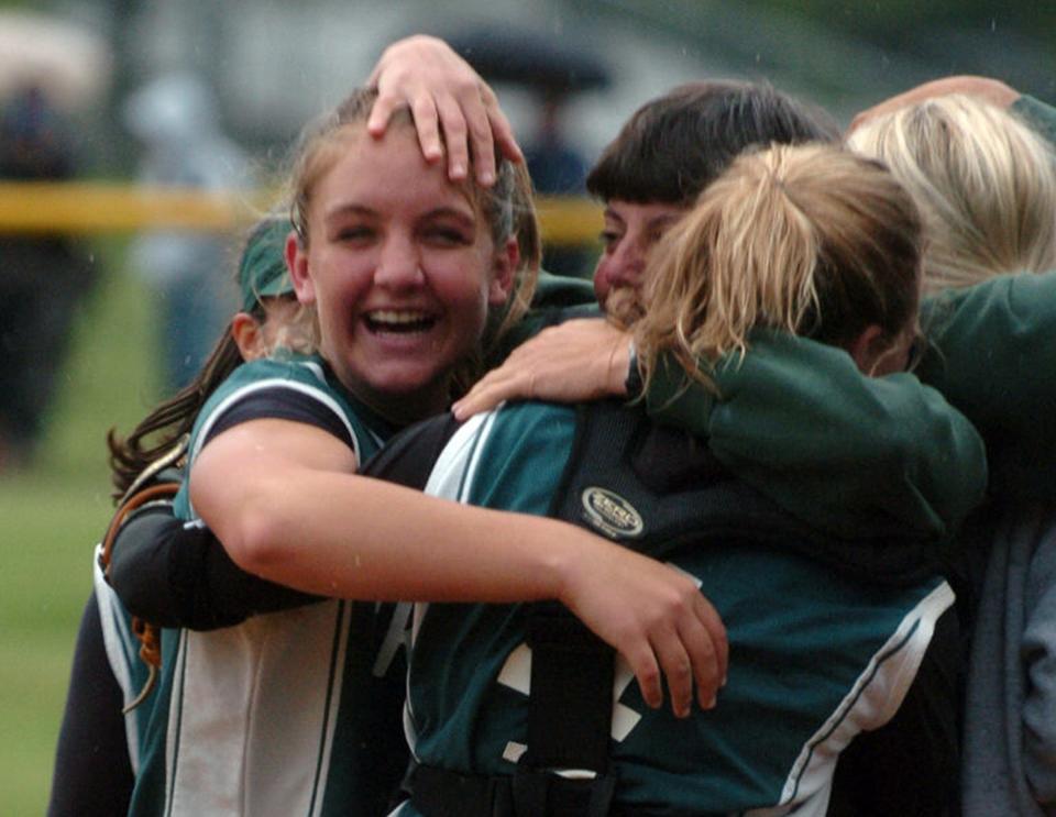 2006 - Ramapo Head Coach Leslie Stephen hugging pitcher Brittany Baiuncol (7) and catcher Sam Depken (4) after beating Tenafly Sunday in the Bergen County Girls Softball Tournament Final at Northern Valley Old Tappan High School in Old Tappan. Beth Balbierz / The Record