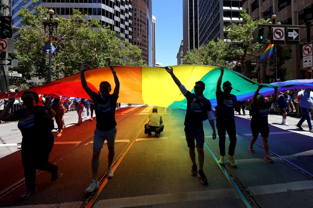 Marchers carry an oversized Pride flag during the 52nd annual San Francisco Pride Parade and Celebration on June 26, 2022 in San Francisco, California. Thousands of people came out to the annual SF Pride Parade after a two-year hiatus due to the COVID-19 pandemic.